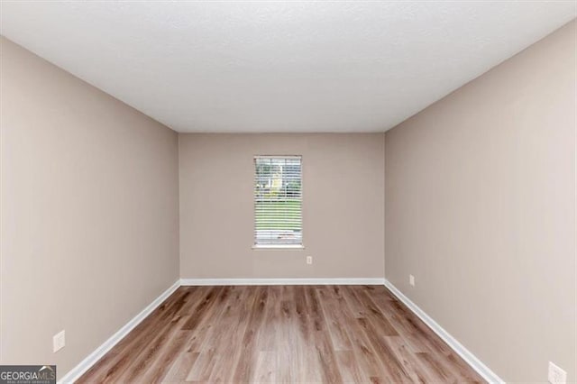 5290 Forest Downs Ln, Atlanta, GA 30349 - spare room featuring light wood-style floors and baseboards