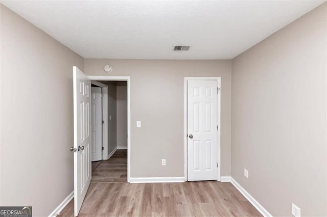 5290 Forest Downs Ln, Atlanta, GA 30349 - unfurnished bedroom with light wood finished floors and baseboards