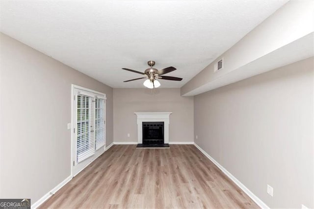 5290 Forest Downs Ln, Atlanta, GA 30349 - unfurnished living room with a ceiling fan, light wood-type flooring, a fireplace, and baseboards