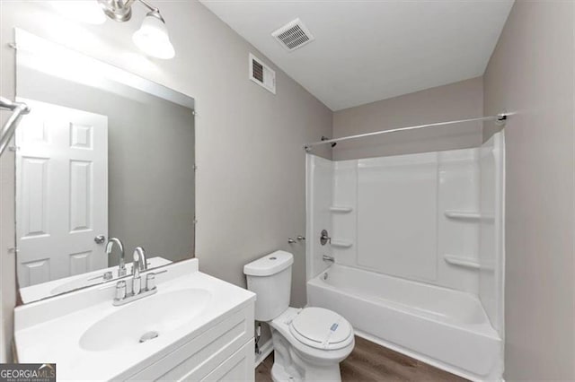 5290 Forest Downs Ln, Atlanta, GA 30349 - full bathroom featuring wood finished floors, toilet, vanity, and washtub / shower combination