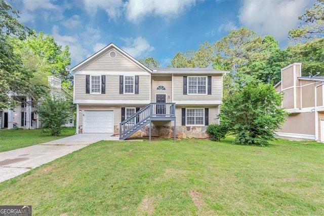 5290 Forest Downs Ln, Atlanta, GA 30349 - bi-level home featuring concrete driveway, a front lawn, and a garage