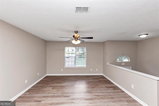 5290 Forest Downs Ln, Atlanta, GA 30349 - spare room with healthy amount of natural light, a ceiling fan, wood finished floors, and baseboards