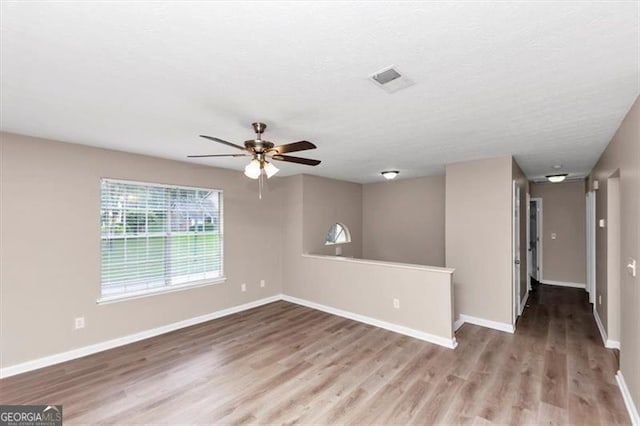 5290 Forest Downs Ln, Atlanta, GA 30349 - empty room featuring wood finished floors, a ceiling fan, and baseboards