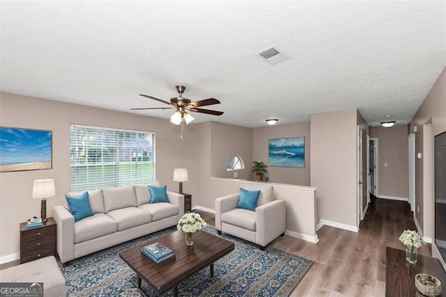 5290 Forest Downs Ln, Atlanta, GA 30349 - living area featuring baseboards, wood finished floors, and a ceiling fan
