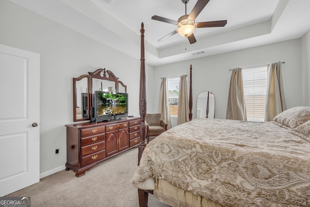 70 Wisteria Way, Winder, GA 30680 - bedroom featuring light carpet, a tray ceiling, baseboards, and ceiling fan