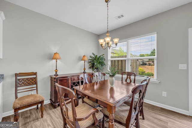 70 Wisteria Way, Winder, GA 30680 - dining space with light wood-style floors, a chandelier, and baseboards