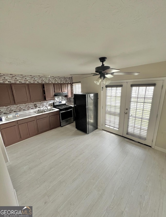 1625 Conley Rd Unit 139, Conley, GA 30288 - kitchen featuring freestanding refrigerator, stainless steel range with gas cooktop, a ceiling fan, french doors, and tasteful backsplash