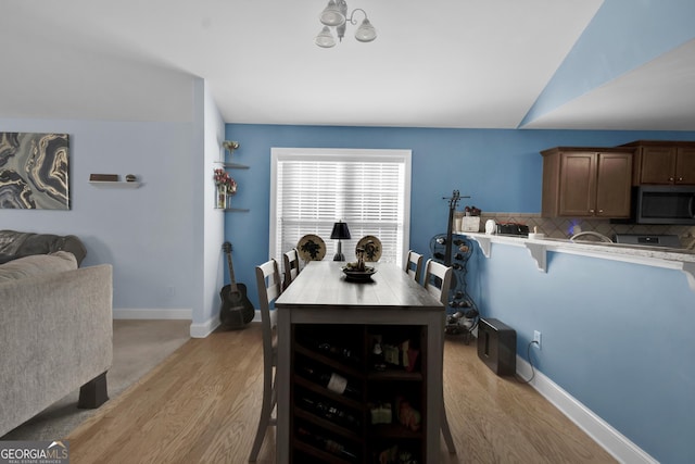 1885 Hickory Station Cir, Snellville, GA 30078 - dining area featuring light wood-style flooring and baseboards
