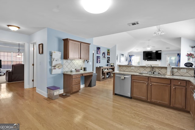 1885 Hickory Station Cir, Snellville, GA 30078 - kitchen featuring stainless steel dishwasher, a sink, decorative backsplash, light wood-style flooring, and lofted ceiling