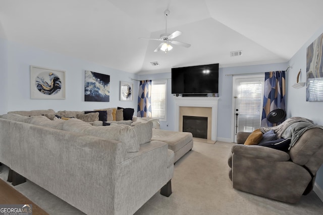 1885 Hickory Station Cir, Snellville, GA 30078 - living room with a ceiling fan, vaulted ceiling, a glass covered fireplace, light colored carpet, and baseboards