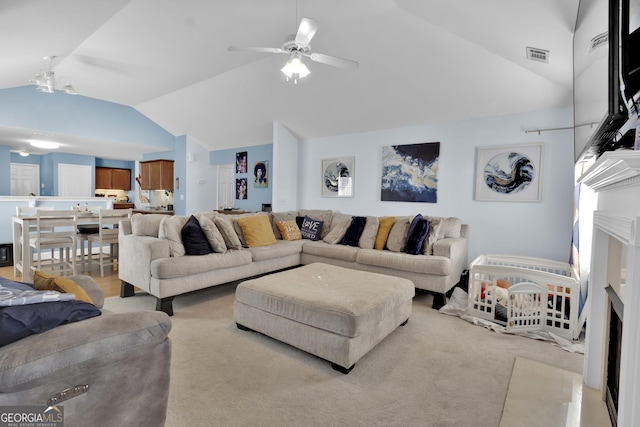 1885 Hickory Station Cir, Snellville, GA 30078 - living room featuring lofted ceiling, a ceiling fan, and light colored carpet