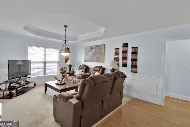 1885 Hickory Station Cir, Snellville, GA 30078 - living area with crown molding, a tray ceiling, wainscoting, and light wood finished floors