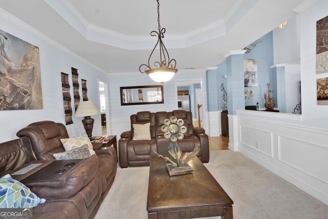 1885 Hickory Station Cir, Snellville, GA 30078 - carpeted living room featuring a decorative wall, a tray ceiling, ornamental molding, and a wainscoted wall