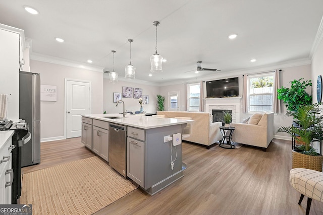 3610 Silvery Way, Powder Springs, GA 30127 - kitchen featuring gray cabinetry, a sink, appliances with stainless steel finishes, healthy amount of natural light, and crown molding