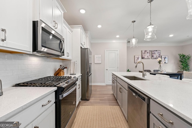 3610 Silvery Way, Powder Springs, GA 30127 - kitchen featuring stainless steel appliances, a sink, crown molding, decorative backsplash, and light wood-style floors