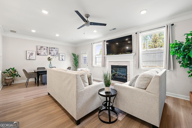 3610 Silvery Way, Powder Springs, GA 30127 - living room featuring ceiling fan, baseboards, a stone fireplace, light wood-type flooring, and crown molding