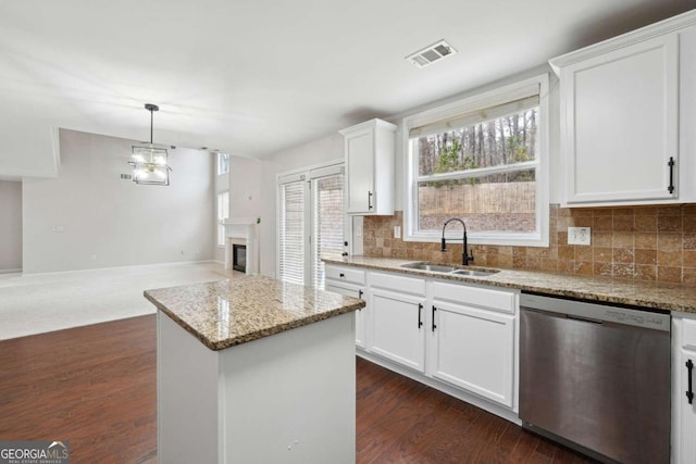 1736 Dylan Pl, Lawrenceville, GA 30043 - kitchen with dishwasher, open floor plan, light stone countertops, tasteful backsplash, and a center island