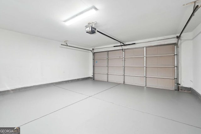1736 Dylan Pl, Lawrenceville, GA 30043 - garage featuring a garage door opener and baseboards