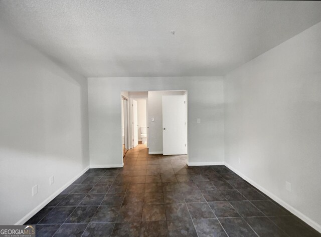 219 Cobblestone Trl, Avondale Estates, GA 30002 - unfurnished room with baseboards, tile patterned floors, and a textured ceiling
