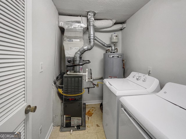 219 Cobblestone Trl, Avondale Estates, GA 30002 - washroom with independent washer and dryer, gas water heater, a textured ceiling, and baseboards