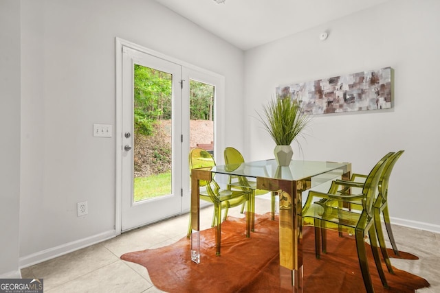 dining room with baseboards and light tile patterned floors