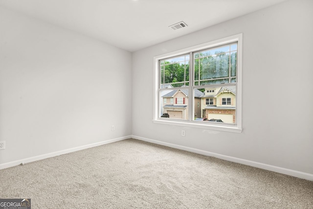 carpeted spare room with baseboards