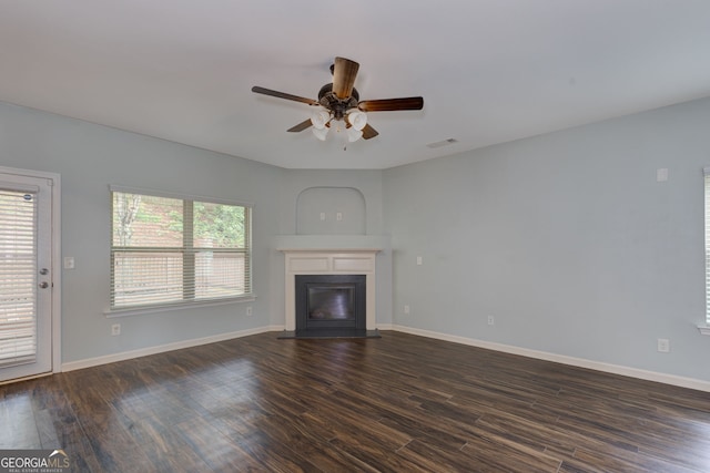 49 Torero Trl, Newnan, GA 30263 - unfurnished living room featuring a glass covered fireplace, a ceiling fan, dark wood finished floors, and baseboards