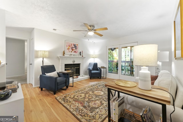 1424 Tuxworth Cir, Decatur, GA 30033 - living area featuring a ceiling fan, light wood finished floors, and a fireplace