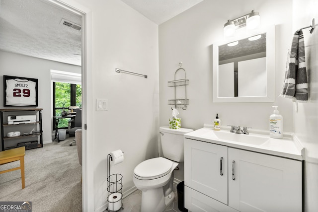 1424 Tuxworth Cir, Decatur, GA 30033 - bathroom featuring vanity, toilet, a textured ceiling, and baseboards