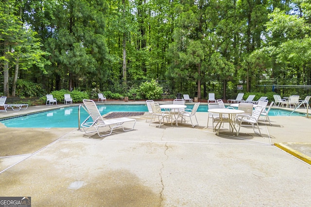 1424 Tuxworth Cir, Decatur, GA 30033 - community pool featuring a patio area and view of scattered trees