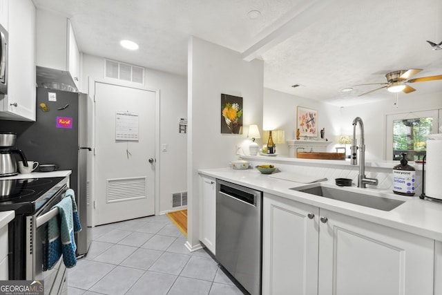 1424 Tuxworth Cir, Decatur, GA 30033 - kitchen with appliances with stainless steel finishes, a sink, white cabinetry, and light tile patterned flooring