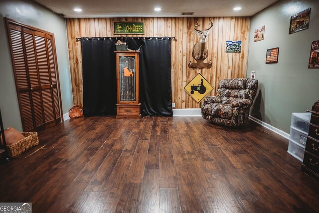 living area featuring baseboards, hardwood / wood-style flooring, and recessed lighting