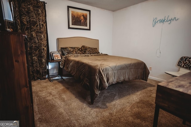 carpeted bedroom featuring baseboards