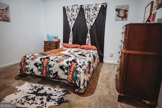 bedroom featuring carpet and baseboards