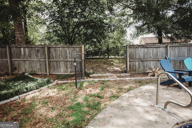 fenced backyard with a patio area