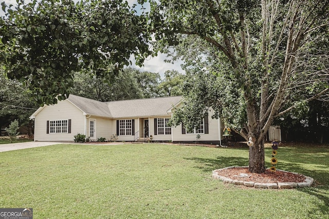ranch-style home with a front lawn and driveway