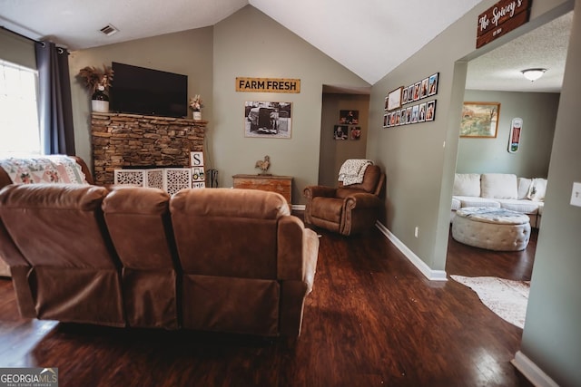 living room with wood finished floors, lofted ceiling, and baseboards