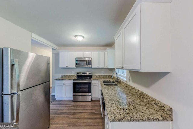 3197 Ward Dr SW, Atlanta, GA 30354 - kitchen with stainless steel appliances, a sink, white cabinetry, light stone countertops, and dark wood-style floors