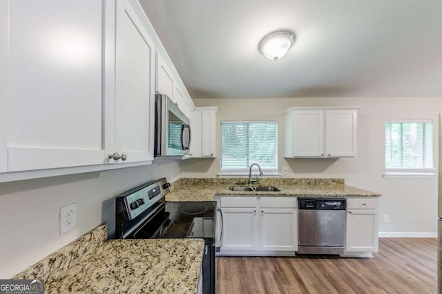 3197 Ward Dr SW, Atlanta, GA 30354 - kitchen featuring stainless steel appliances, a sink, white cabinetry, and plenty of natural light