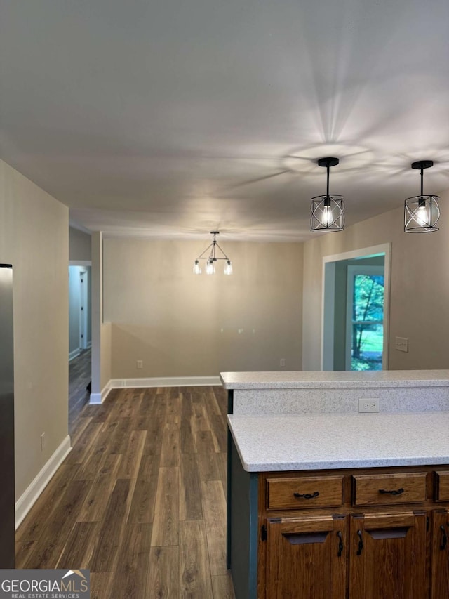 5540 Farm House Ln, Oakwood, GA 30566 - kitchen with dark wood-style floors, hanging light fixtures, and baseboards