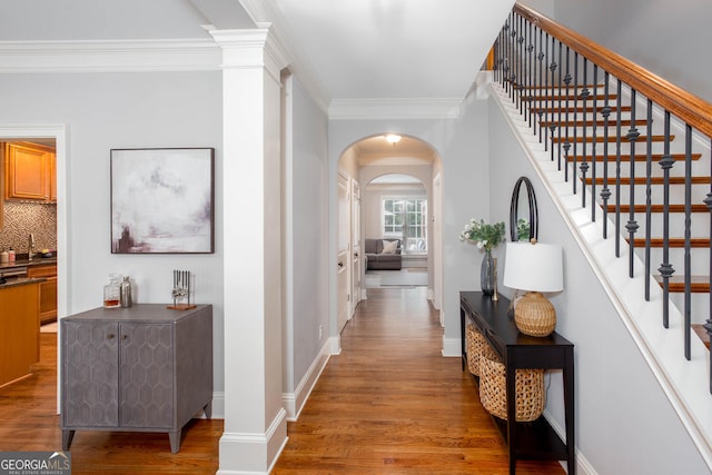 855 Mountain View Ter NW, Marietta, GA 30064 - hallway featuring wood finished floors, crown molding, arched walkways, stairs, and baseboards