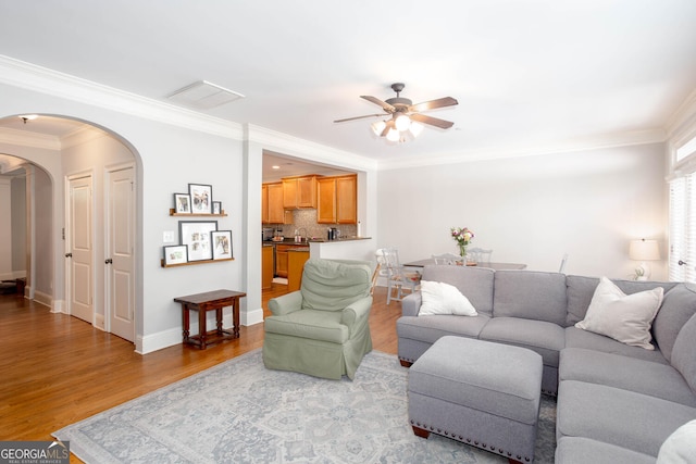 855 Mountain View Ter NW, Marietta, GA 30064 - living room featuring arched walkways, a ceiling fan, wood finished floors, crown molding, and baseboards