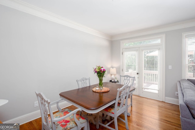 855 Mountain View Ter NW, Marietta, GA 30064 - dining space featuring crown molding, french doors, baseboards, and light wood-style floors
