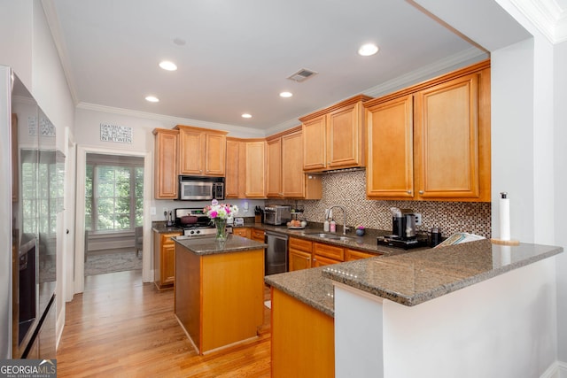 855 Mountain View Ter NW, Marietta, GA 30064 - kitchen featuring stainless steel appliances, a sink, dark stone countertops, a center island, and light wood-style flooring