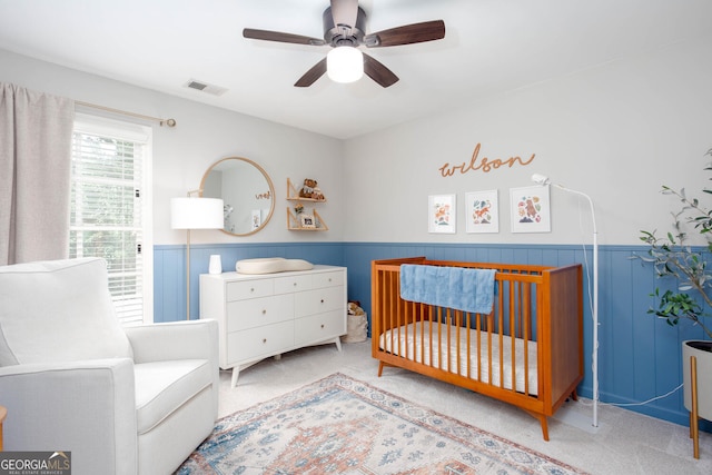 855 Mountain View Ter NW, Marietta, GA 30064 - bedroom featuring carpet, a wainscoted wall, a crib, and a ceiling fan