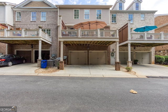 855 Mountain View Ter NW, Marietta, GA 30064 - back of property featuring a garage, brick siding, driveway, and central AC