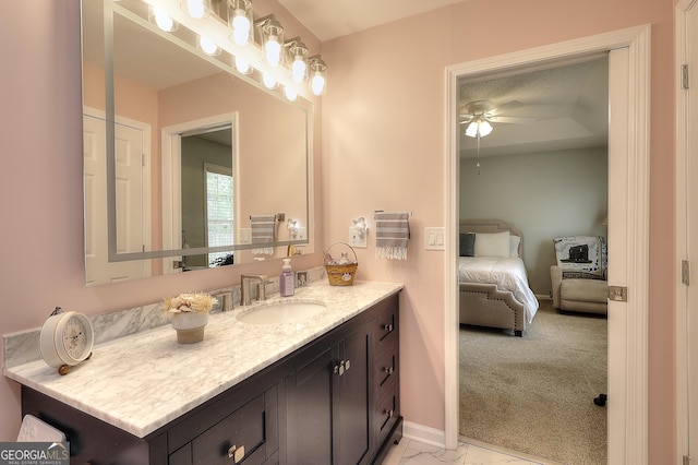 bathroom with a ceiling fan, vanity, baseboards, ensuite bath, and marble finish floors