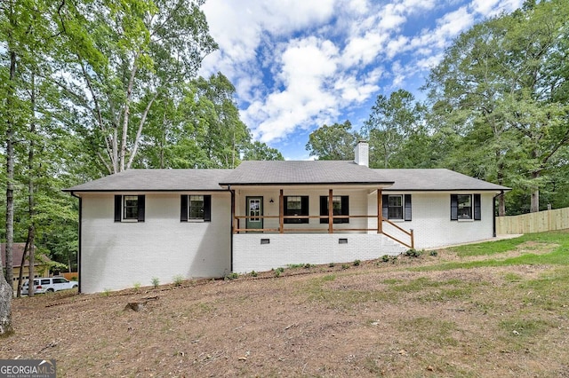 single story home with brick siding, a chimney, and a porch