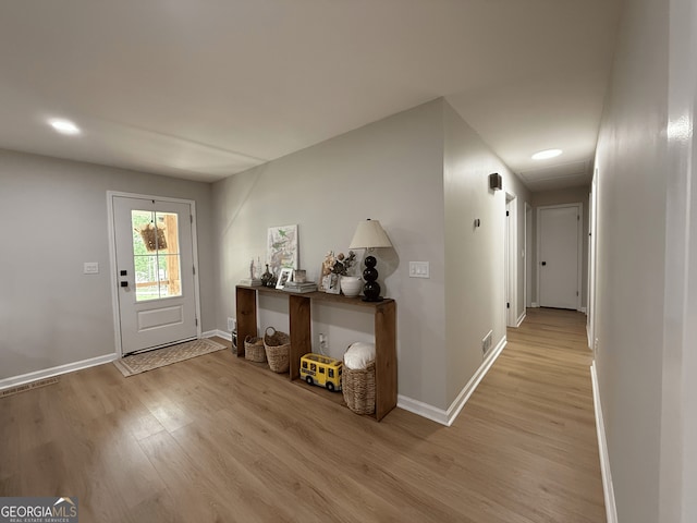 entrance foyer featuring light wood-style floors, baseboards, and recessed lighting