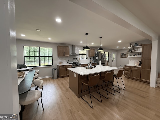 kitchen with wall chimney range hood, recessed lighting, stainless steel appliances, light wood-style floors, and open shelves